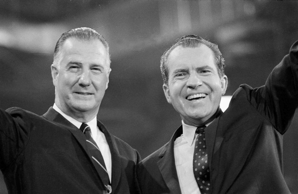 FILE - Richard M. Nixon waves to Republican National Convention delegates as he stands with his running mate Gov. of Maryland, Spiro T. Agnew in Miami, Aug. 8, 1968, after accepting the party's nomination as a presidential candidate. Agnew’s resignation was announced by his attorney, and the former vice president expeditiously pleaded no contest to failing to report $29,500 in federal taxes in 1967. In exchange, federal prosecutors declined to bring far more serious charges of bribery, extortion and conspiracy. (AP Photo, File)