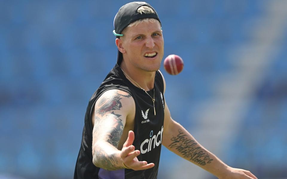 Brydon Carse tossing a ball during net practice in Multan