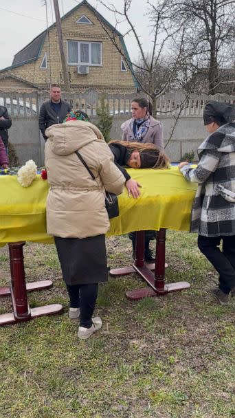 PHOTO: Maria Pylypets hugs the coffin of her husband, Oleksandr Pylypets, at his funeral. Oleksandr was killed in action in the Kherson region. (Tom Soufi Burridge/ABC News)