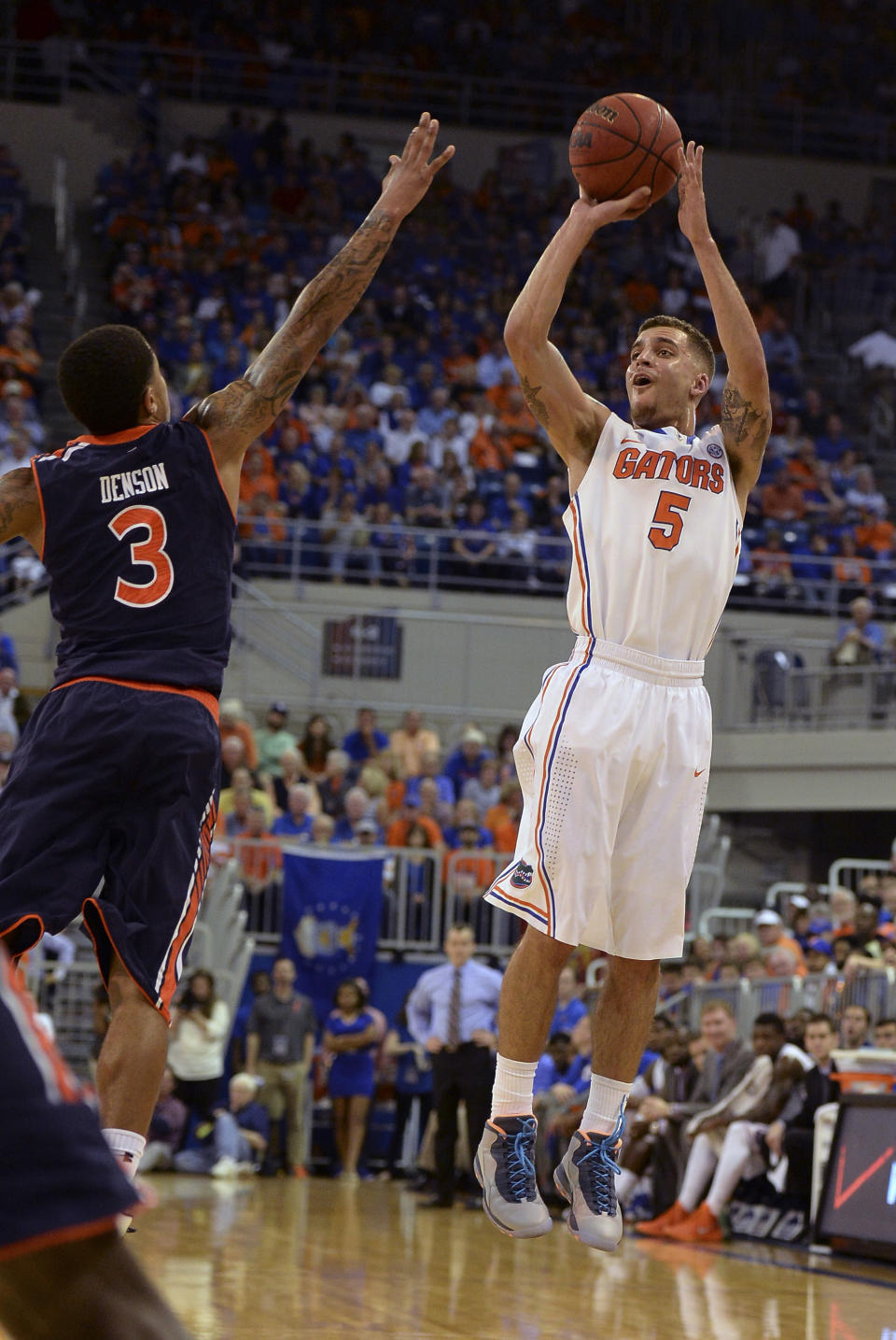 Florida guard Scottie Wilbekin (5) shoots for three points with Auburn guard Chris Denson (3) trying to break up the shot during the first half of an NCAA college basketball game Wednesday Feb. 19, 2014 in Gainesville, Fla. (AP Photo/Phil Sandlin)