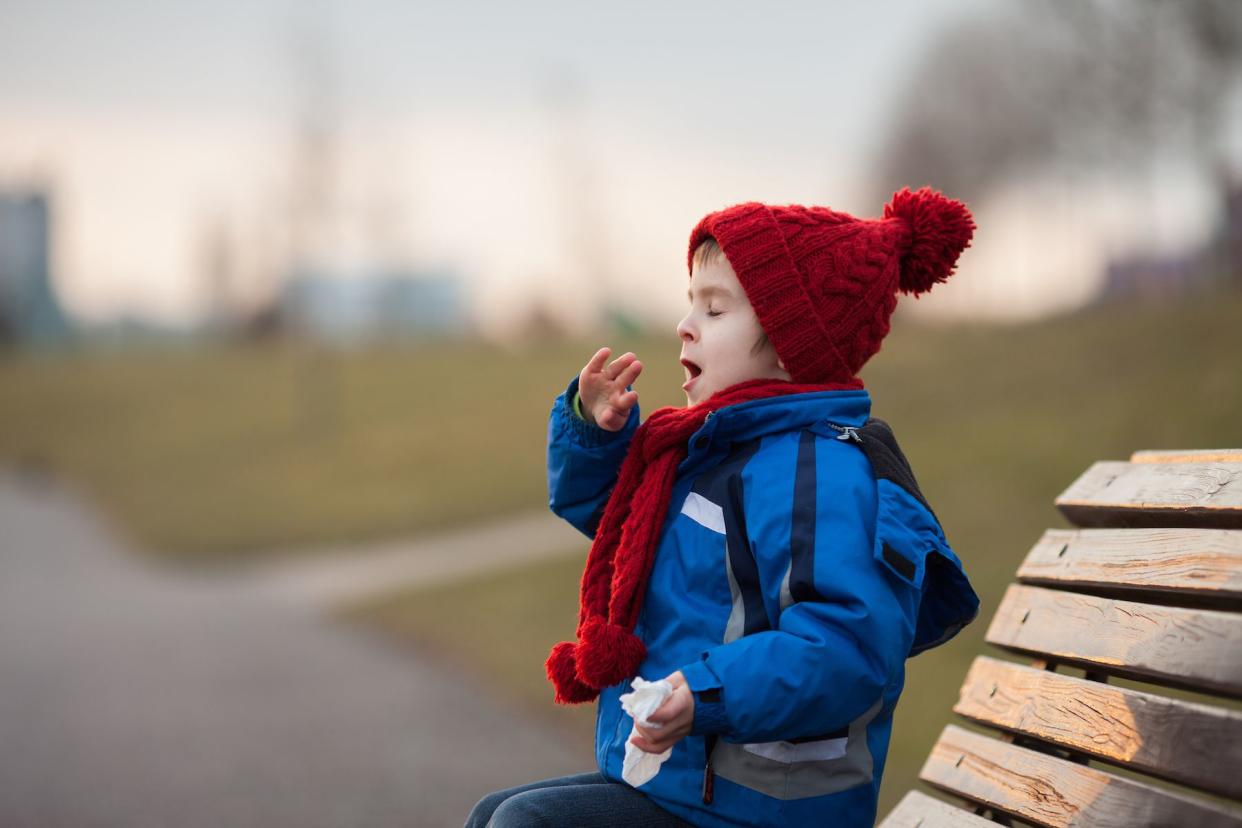 boy coughing outside