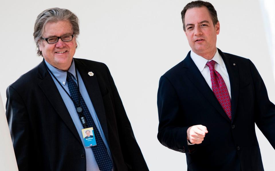 Steve Bannon (left) and White House Chief of Staff Reince Priebus walk through the colonnade of the White House - Credit: AFP