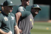 Oakland Athletics' Josh Phegley (19) and Khris Davis, right, warm up during baseball practice in Oakland, Calif., Tuesday, Oct. 1, 2019. The Athletics are scheduled to face the Tampa Bay Rays in an American League wild-card game Wednesday, Oct. 2. (AP Photo/Jeff Chiu)