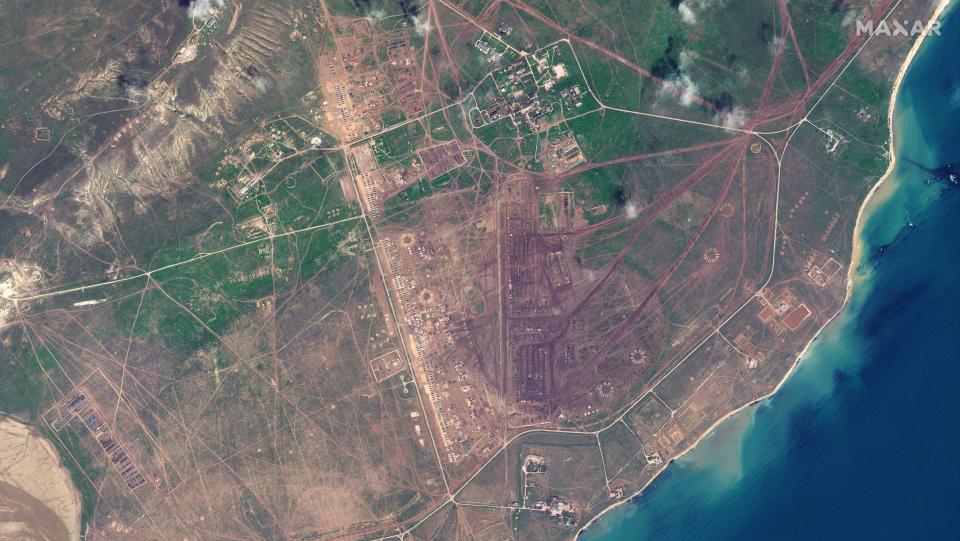 This image provided by Maxar Technologies shows overview of deployments at Opuk training area at the Black Sea coast of Crimea on Thursday, April 15, 2021. Russia has insisted that it has the right to restrict foreign naval ships' movement off Crimea, rejecting Ukrainian complaints and Western criticism. Ukraine last week protested the Russian move to close broad areas of the Black Sea near Crimea to foreign navy ships and state vessels until November. (Satellite image ©2021 Maxar Technologies via AP)