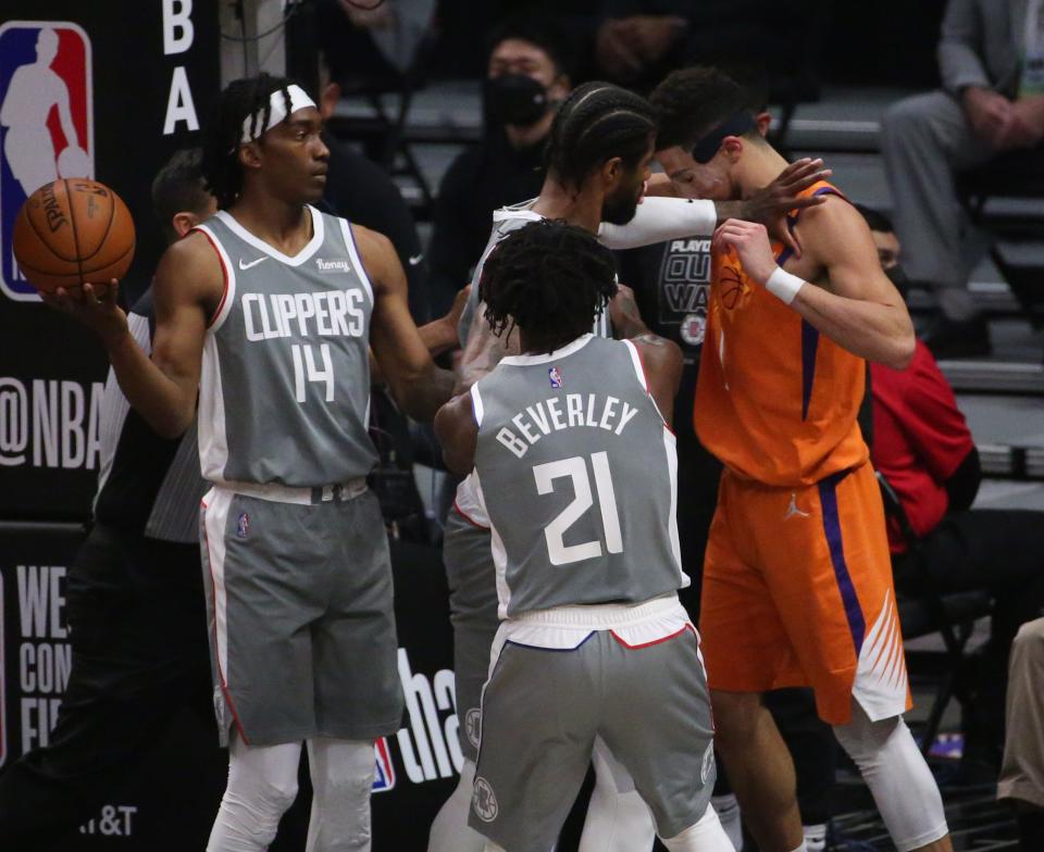 LA Clippers guard Paul George (13) shoves Phoenix Suns guard Devin Booker (1) after a foul during Game 4 at STAPLES Center June 26, 2021.