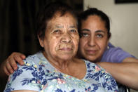 Eugenia Rodriguez, right, and her 84-year-old non-citizen mother, Francisca Perez, pose for a portrait in their house Wednesday, June 30, 2021, in Chicago's Little Village neighborhood. Rodriguez hasn't been eligible for insurance coverage after overstaying a visitor visa from Mexico. She used to wake up every two or three hours at night to check on her mother. Since getting health insurance through the Illinois program, her mother has all the medications she needs. (AP Photo/Shafkat Anowar)