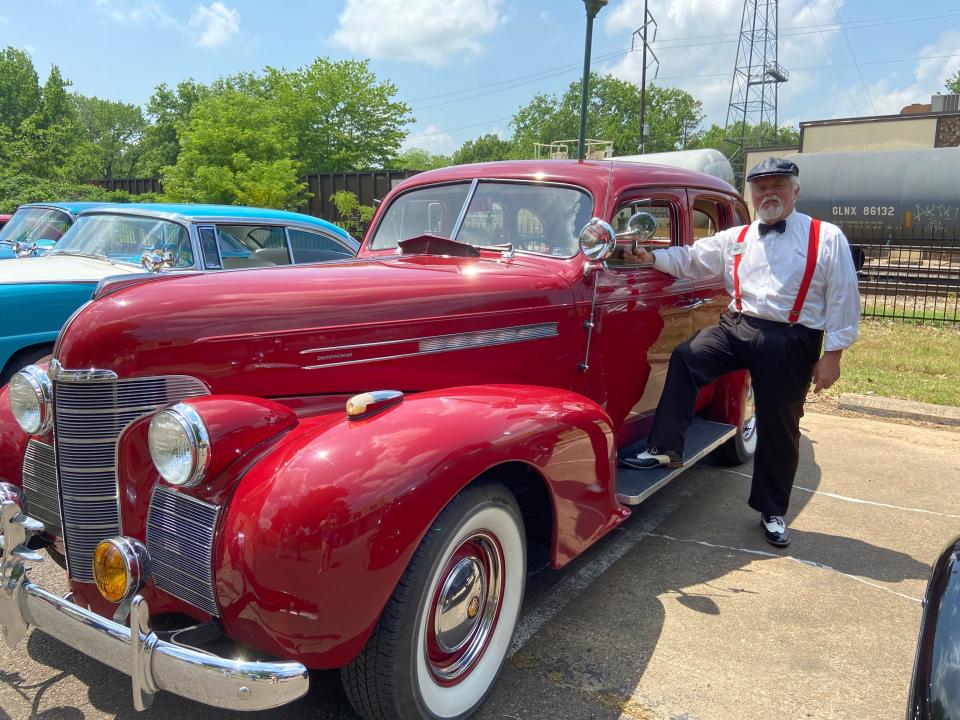 Carl Albertson, president of the Fort Smith Antique Auto Club, stands with his car.