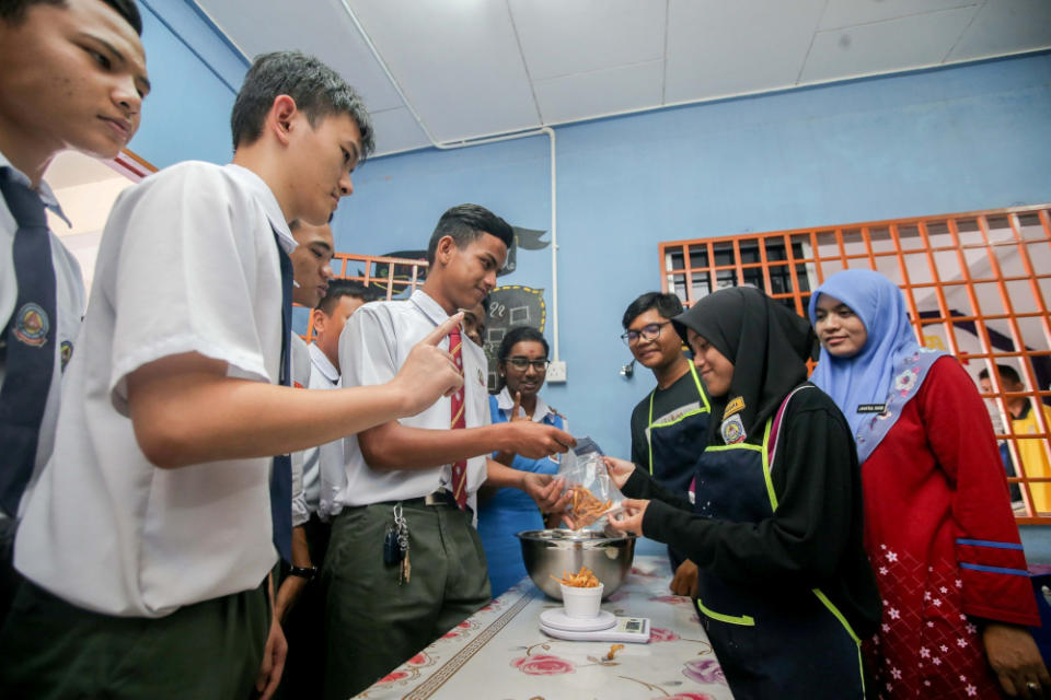 Some of the mushrooms cultivated are fried and sold during recess time. — Picture by Farhan Najib