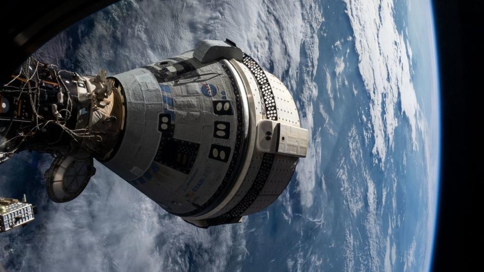     A cone-shaped spacecraft visible above the curve of the Earth, with clouds. 