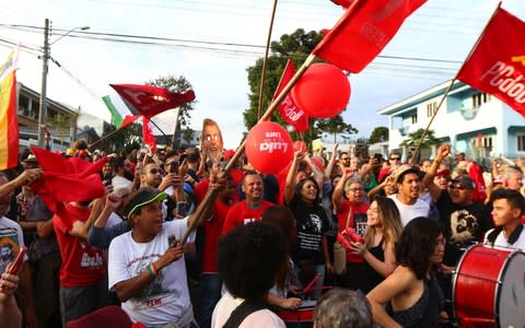 Supporters of Luiz Inacio Lula da Silva demonstrate outside the Federal Police where he is detainee in Curitiba - Credit: Franklin De Freitas/AFP