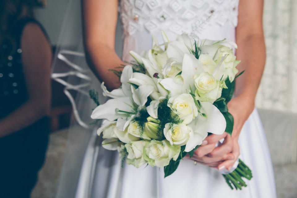 Bride holding bouquet of white flowers