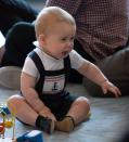 Britain's Prince George plays during a visit to Plunket nurse and parents group at Government House in Wellington, New Zealand, Wednesday, April 9, 2014. Plunket is a national not-for-profit organization that provides care for children and families in New Zealand. Britain's Prince William, his wife Kate, the Duchess of Cambridge and their son, Prince George, are on a three-week tour of New Zealand and Australia. (AP Photo/Marty Melville, Pool)