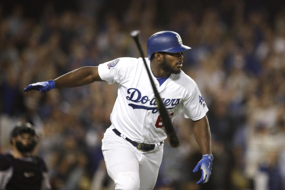 Dodgers slugger Yasiel Puig celebrates his clutch three-run homer against the Rockies with another epic bat flip. (AP)