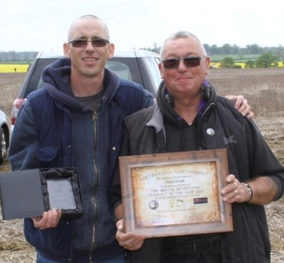 Paul Wood, right, who found a gold ring while metal detecting. It has sold at auction for £10,000. (SWNS)