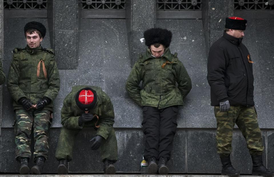 Cossacks guard the regional parliament building during the Crimean referendum in Simferopol, Ukraine, Sunday, March 16, 2014. Residents of Ukraine's Crimea region are voting in a contentious referendum on whether to split off and seek annexation by Russia. (AP Photo/Vadim Ghirda)