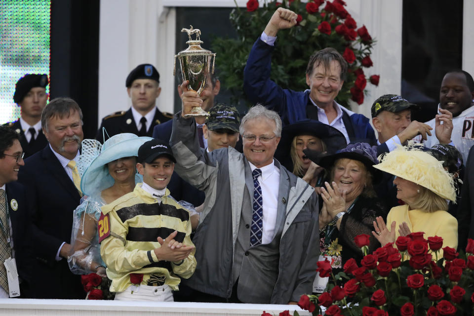 Jockey Flavien Prat and trainer Bill Mott of Country House celebrate with the trophy after winning the 145th running of the Kentucky Derby. (Getty Images)