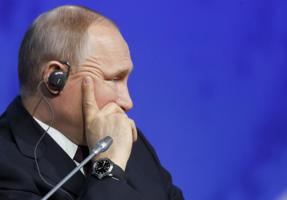 Russian President Vladimir Putin listens during a plenary session of the International Arctic Forum in St. Petersburg, Russia, Tuesday, April 9, 2019. Putin on Tuesday put forward an ambitious program to secure Russia's foothold in the Arctic, including efforts to build new ports and other infrastructure facilities and expand an icebreaker fleet. (AP Photo/Dmitri Lovetsky)