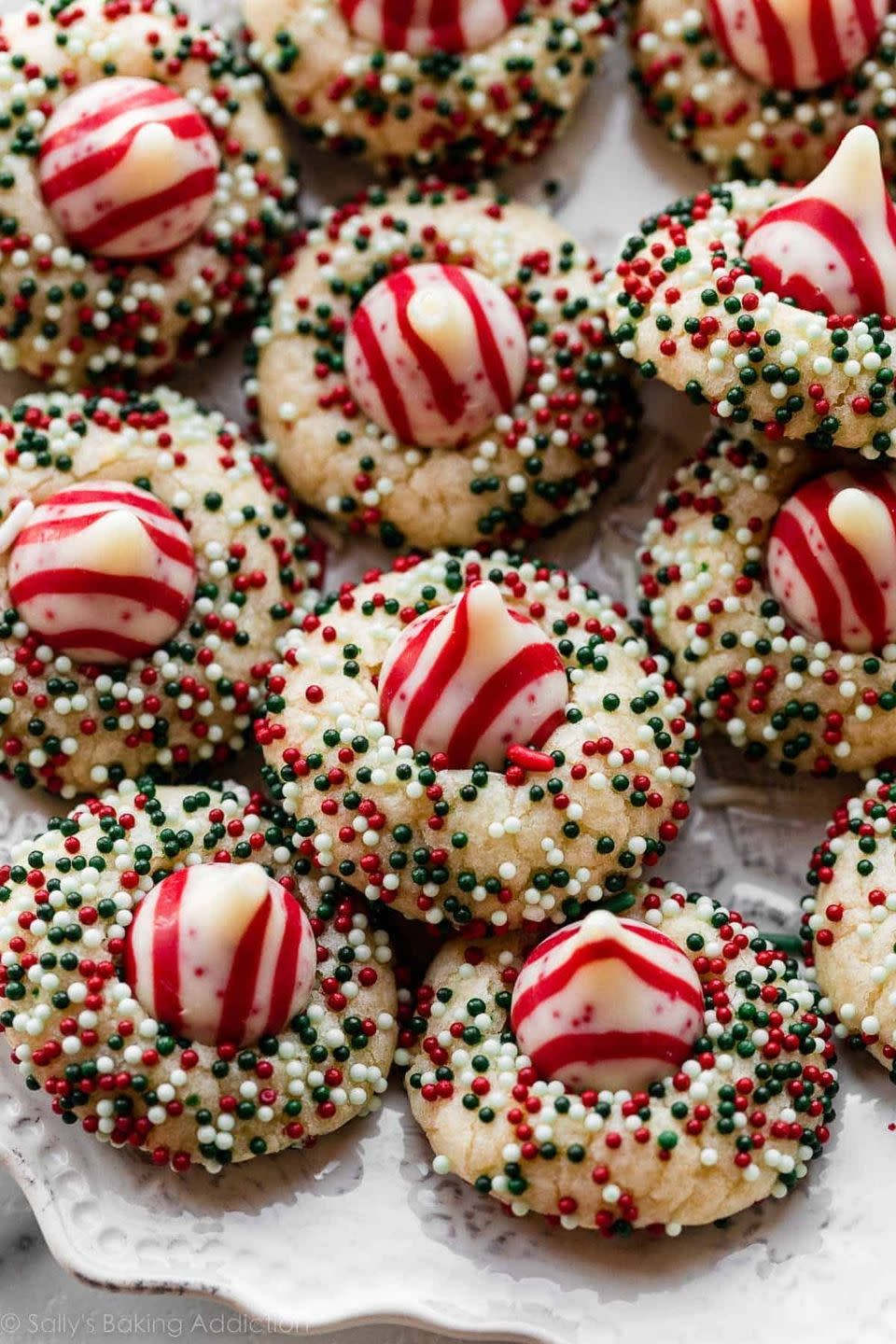 <p>Does it get any more cute and festive than these cookies? They're drop-style cookies, meaning all you have to do is scoop and bake. Roll them in your favorite sprinkles before baking and top with a Candy Cane Kiss! </p><p><strong>Get the recipe for <a href="https://sallysbakingaddiction.com/candy-cane-kiss-cookies/" rel="nofollow noopener" target="_blank" data-ylk="slk:Candy Cane Kiss Cookies;elm:context_link;itc:0;sec:content-canvas" class="link ">Candy Cane Kiss Cookies</a> at Sally's Baking Addiction.</strong></p>