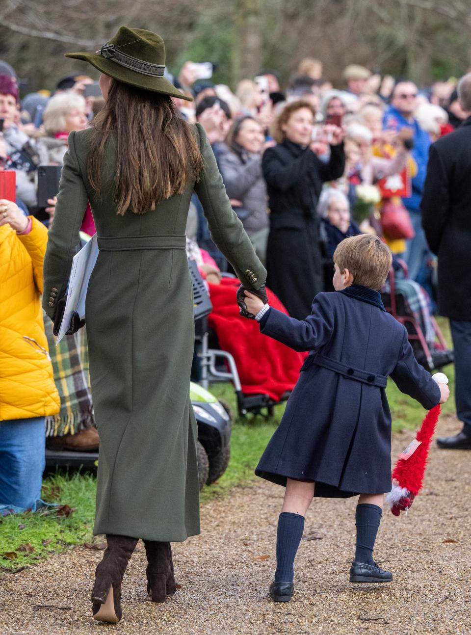 Prince Louis pulls on Kate Middleton's hand at Sandringham on Christmas