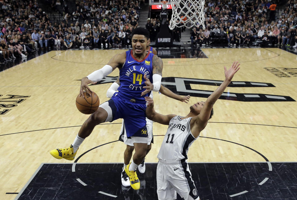 Denver Nuggets guard Gary Harris (14) drives to the basket past San Antonio Spurs guard Bryn Forbes (11) during the first half of Game 4 of an NBA basketball playoff series in San Antonio, Saturday, April 20, 2019. (AP Photo/Eric Gay)