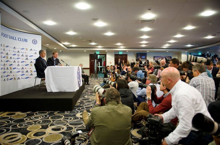 Chelsea football club's new manager Jose Mourinho (L) addresses a press conference at Stamford Bridge in London, on June 10, 2013. A more cautious Mourinho transformed himself into "the Happy One" on Monday as he faced the media for the first time since he began his second spell as manager of Premier League giants Chelsea