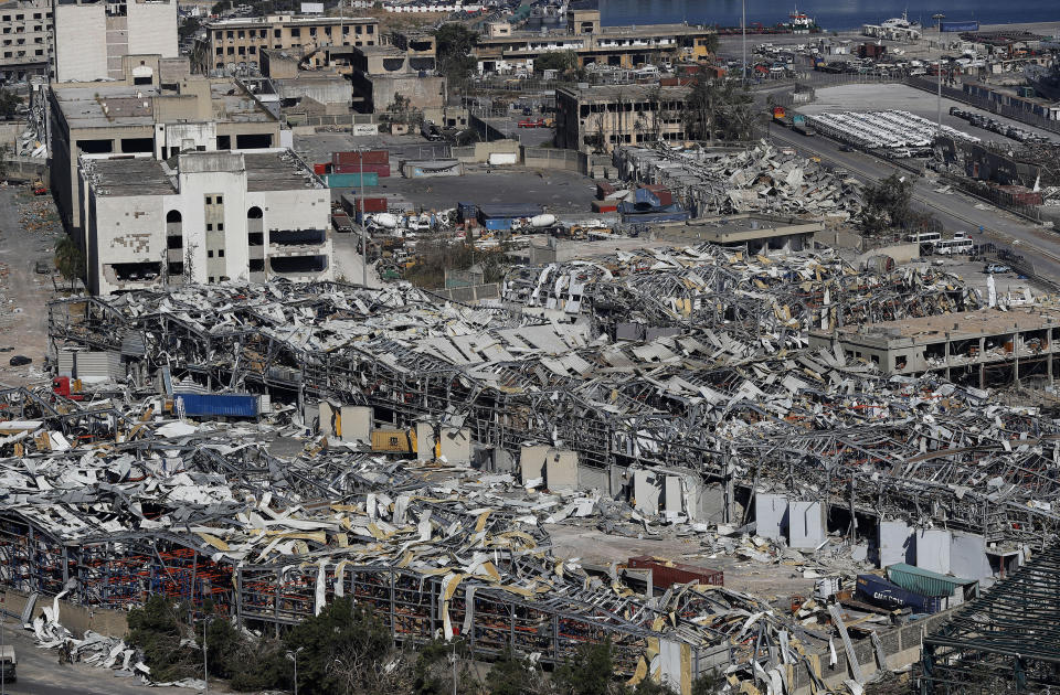 A general view shows the port warehouses destroyed by Tuesday's explosion that hit the seaport of Beirut, Lebanon, Friday, Aug. 7, 2020. Rescue teams were still searching the rubble of Beirut's port for bodies on Friday, nearly three days after a massive explosion sent a wave of destruction through Lebanon's capital, killing over a hundred people and wounding thousands. (AP Photo/Hussein Malla)