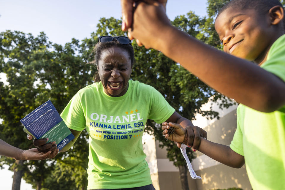 School board trustee hopeful Orjanel Lewis prays with her two children and her mother as the polls close on Election Day on  May 7, 2022, in Ft. Bend County, Texas. (Annie Mulligan for NBC News)