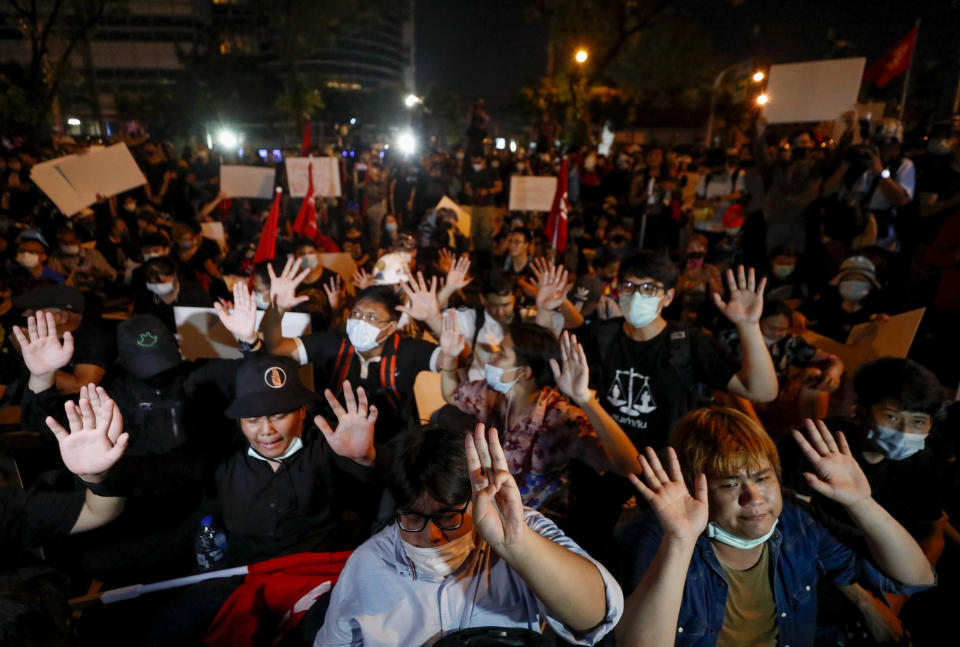 Anti-government protesters gesture, outside the Criminal court during a protest in Bangkok, Thailand, Saturday, March 6, 2021. A new faction of Thailand's student-led anti-government movement calling itself REDEM, short for Restart Democracy, announced plans to march to Bangkok's Criminal Court Saturday to highlight the plight of several detained leaders of the protest movement. (AP Photo/Sakchai Lalit)