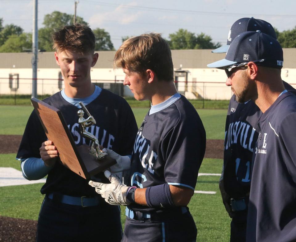 Walker Kandel, left, and Zack Seaman, center, of Louisville accept the runner-up trophy after being defeated in their DII regional final against Chardon at Thurman Munson Memorial Stadium on Friday, June 3, 2022.