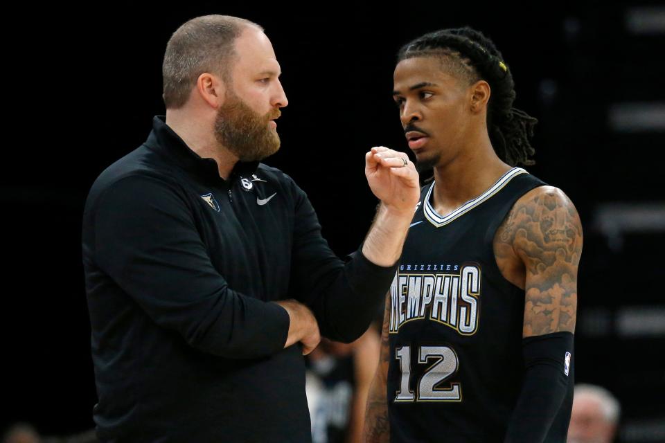 Memphis Grizzlies head coach Taylor Jenkins talks with guard Ja Morant during a December game.