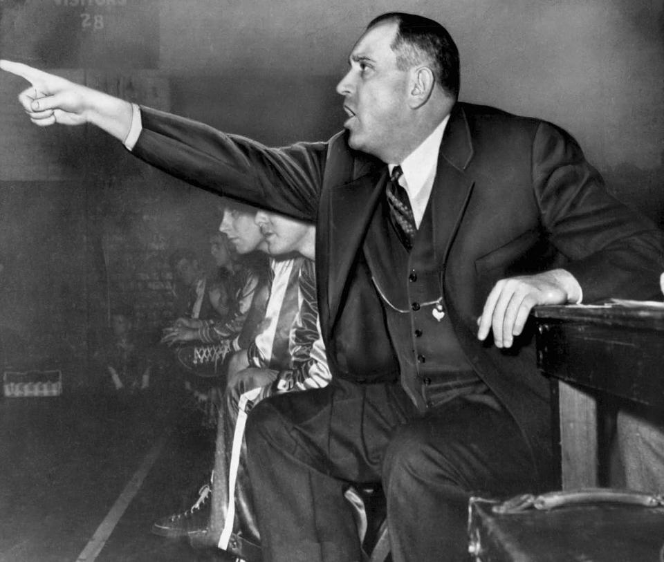 FILE - University of Kentucky coach Adolph Rupp gestures from the bench in Lexington, Ky., in January 1954. (AP Photo/File)