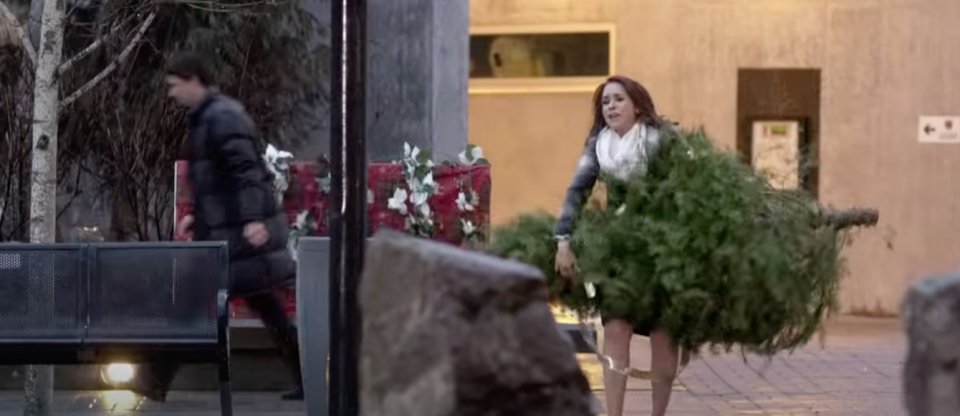 lacey chabert carrying christmas tree in city
