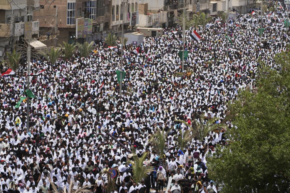 Followers of Shiite cleric Muqtada al-Sadr chant slogans during an open-air Friday prayers in Sadr City, Baghdad, Iraq, Friday, July 15, 2022. (AP Photo/Hadi Mizban)