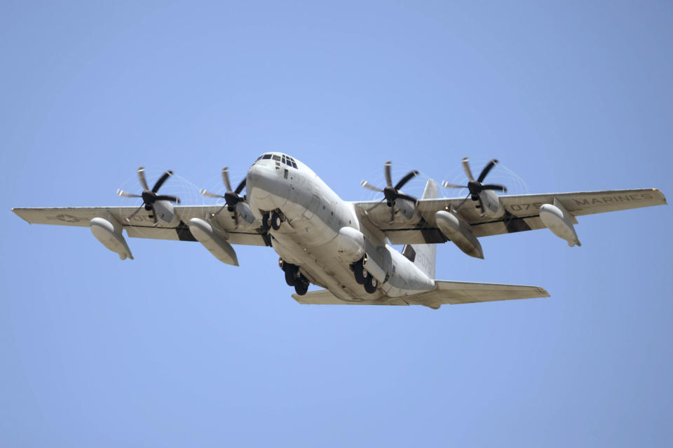 This July, 2014, photo shows a U.S. Marine Corps' KC-130 refueling plane in Ginowan city, Okinawa, southwestern Japan. A search is under way off for crew members from two Marine Corps planes, a F/A-18 and a refueling plane, involved in what officials called a “mishap” off the coast of Japan, Thursday, Dec. 6, 2018. (Yuki Sato/Kyodo News via AP)