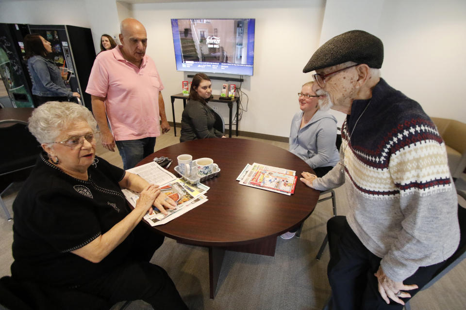 ADDS MORE INFORMATION ON SUBJECTS - Ann Rohrich, left, and husband Richard Rohrich, right, who are not autistic, visit with Elliot Frank, second from right, the president of Autism Housing Development Corporation of Pittsburgh, and fellow residents, Elise Mote, center, and Masha Gregory, second from right, in the recreation room at their apartment in Heidelberg, Pa., Thursday, March 30, 2017. Innovative housing developments like this are popping up across the U.S. to serve those who were diagnosed with autism spectrum disorder as children amid increased awareness about the disorder and changes in how it's defined. ( Photo/Gene J. Puskar)