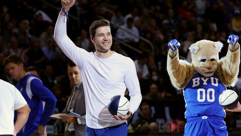 Former BYU star Jimmer Fredette gives a thumbs-up to fans during a timeout as BYU and Utah play at the Marriott Center in Provo on Dec. 17, 2022. Fredette and his wife Whitney Fredette will appear at RootsTech 2024.