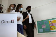 Canadian Minister of International Development Harjit Sajjan, right, listens to Maguy Ghanem a Sexual and Reproductive Health Specialist of United Nations Population Fund (UNFPA), left, during his visit to Makassed primary health care center, in Beirut, Lebanon, Wednesday, Aug. 17, 2022. Sajjan said Syria is not safe yet for millions of refugees to start returning home and those who fled their homes did so only because they had to. He also said , he also said that Lebanon should work to reach a deal with the International Monetary Fund to start getting the small nation out its worst economic crisis in its modern history. (AP Photo/Hussein Malla)