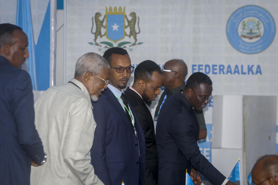 Somali lawmakers cast their votes in the presidential election, at the Halane military camp which is protected by African Union peacekeepers, in Mogadishu, Somalia Sunday, May 15, 2022. Legislators in Somalia are meeting Sunday to elect the country's president in the capital, Mogadishu, which is under lockdown measures aimed at preventing deadly militant attacks. (AP Photo/Farah Abdi Warsameh)