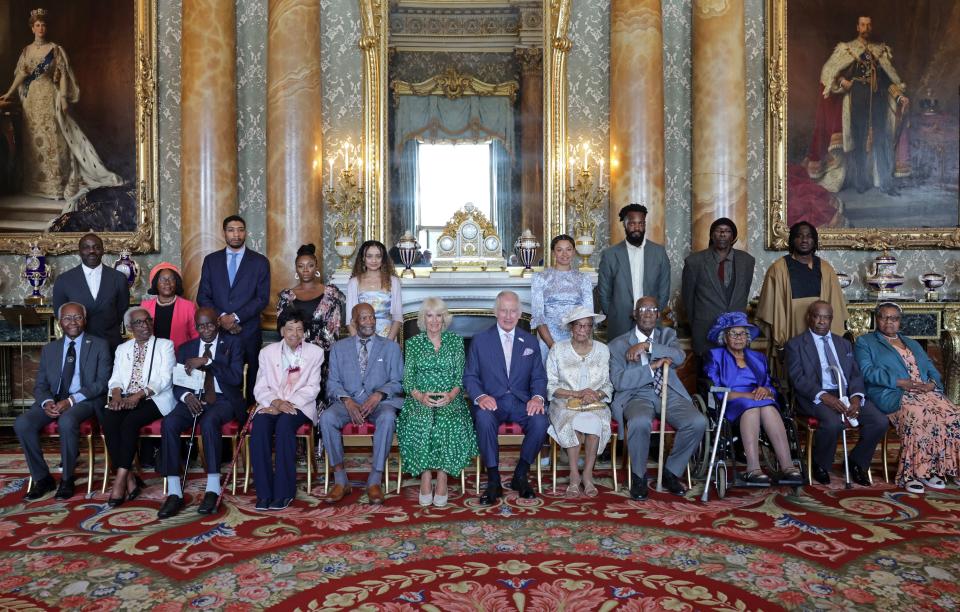 Britain's King Charles III an Britain's Queen Camilla pose in the front row with (L to R) Godfrey Palmer, Carmen Esme Munroe, Delisser Bernard, Linda Haye, Alford Gardener, Jessie Stephens, John Richards, Gilda Oliver, Laceta Reid, and Edna Henry, during a reception to celebrate the Windrush Generation and mark the 75th anniversary of the arrival of the HMT Empire Windrush, at Buckingham Palace, in London, on June 14, 2023. During the reception, ten portraits of Windrush elders were unveiled. (Photo by Chris Jackson / POOL / AFP) (Photo by CHRIS JACKSON/POOL/AFP via Getty Images)