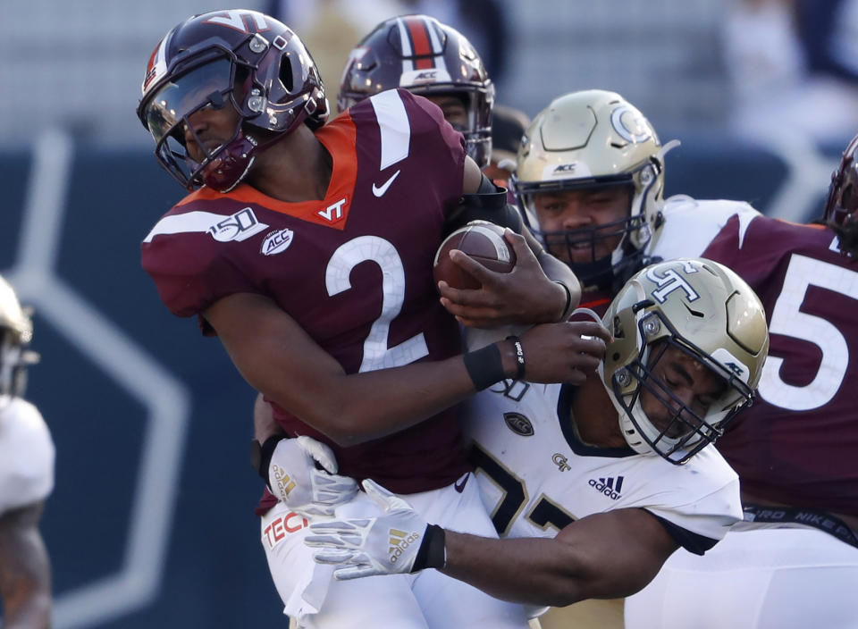 FILE - In this Saturday, Nov. 16, 2019 file photo, Virginia Tech quarterback Knox Kadum (12) is stopped by Georgia Tech defensive lineman Sylvain Yondjouen of Belgium (32) in the first half of an NCAA football game, in Atlanta. Football in Europe usually means “soccer.” But increasingly European kids are excelling at American football. So much so that Europe has become a pipeline of recruits for college football programs — and increasingly for schools from the Power Five conferences. (AP Photo/John Bazemore, file)