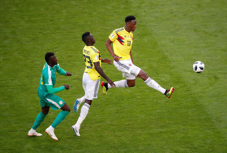 Soccer Football - World Cup - Group H - Senegal vs Colombia - Samara Arena, Samara, Russia - June 28, 2018 Colombia's Yerry Mina and Davinson Sanchez in action with Senegal's M'Baye Niang REUTERS/David Gray