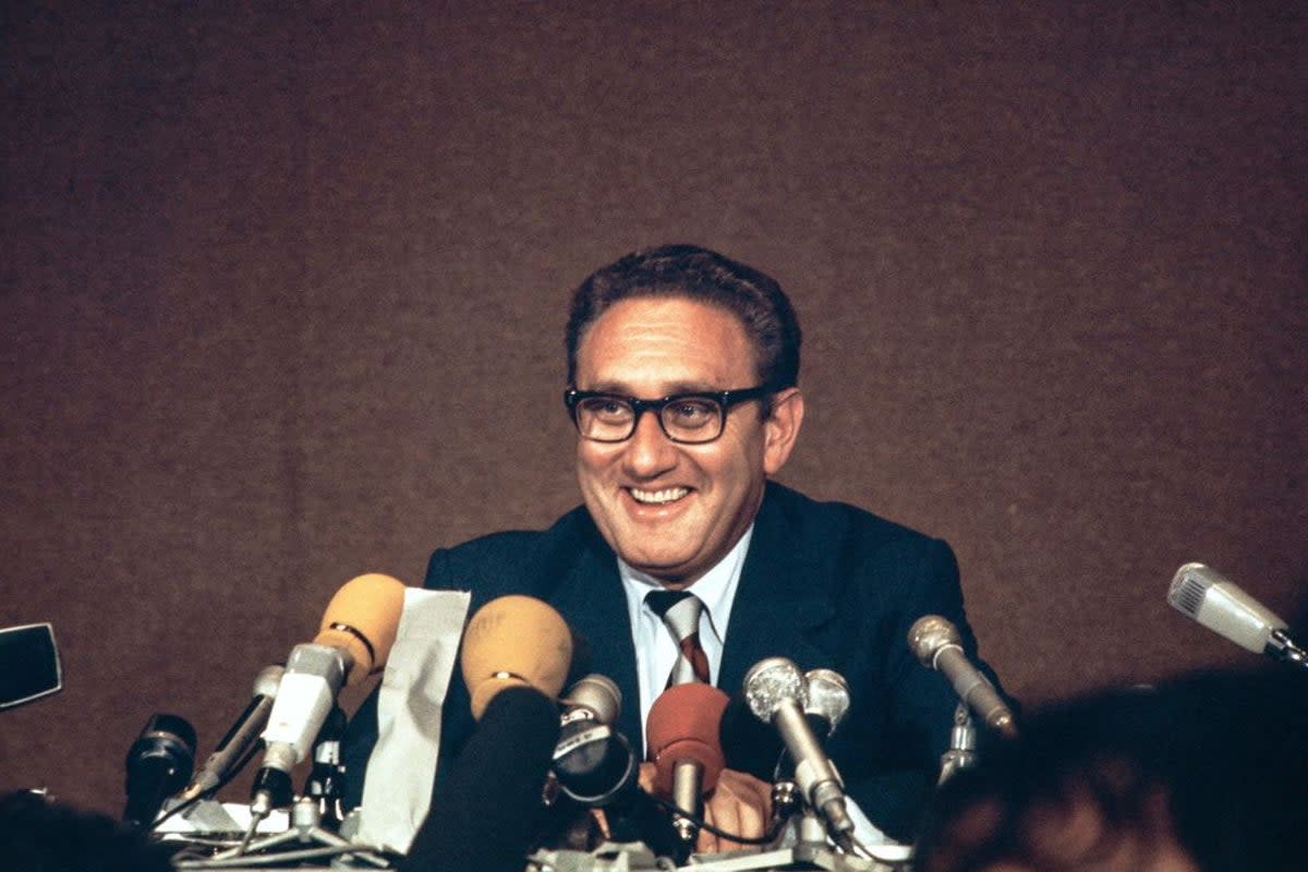 Henry Kissinger laughs during a press conference, after the final communique on the implementation of the Vietnam Peace Accords, signed by Kissinger and the North Vietnamese delegation leader, Le Duc Tho, on 13 June 1973 in Paris (AFP via Getty Images)