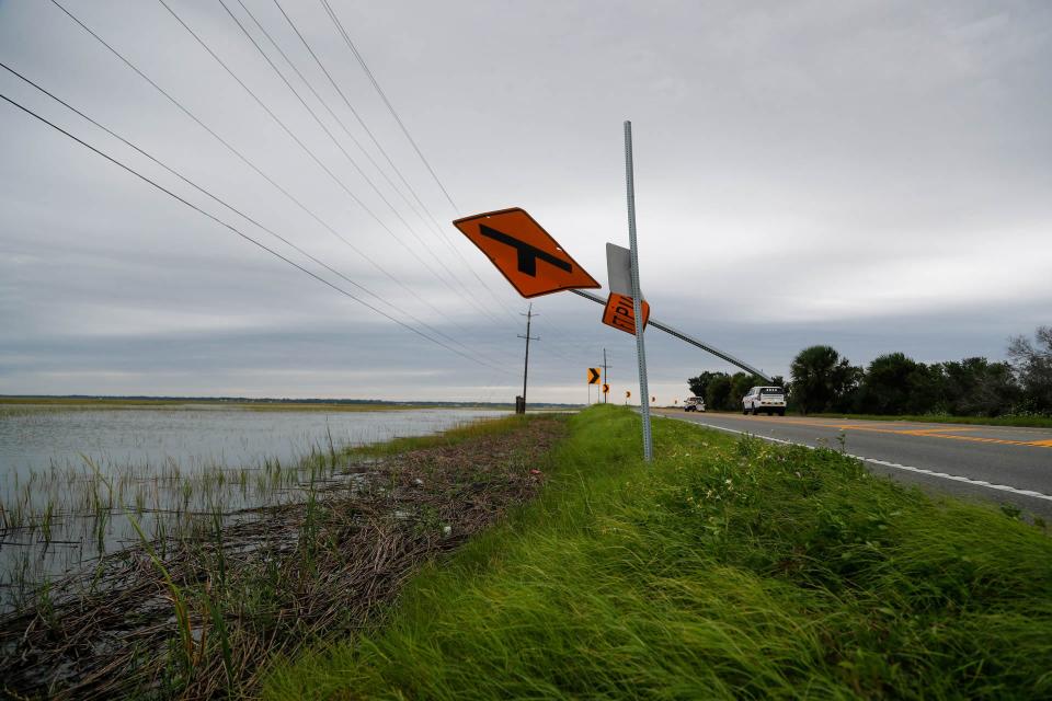 FILE: A sign for Fort Pulaski blows around as high winds batter the area on Thursday September 29, 2022 as Tybee Island felt the impact from Hurricane Ian. The National Park Service said that storms and sea-level rise are one of the causes for planned changes at the historic site.