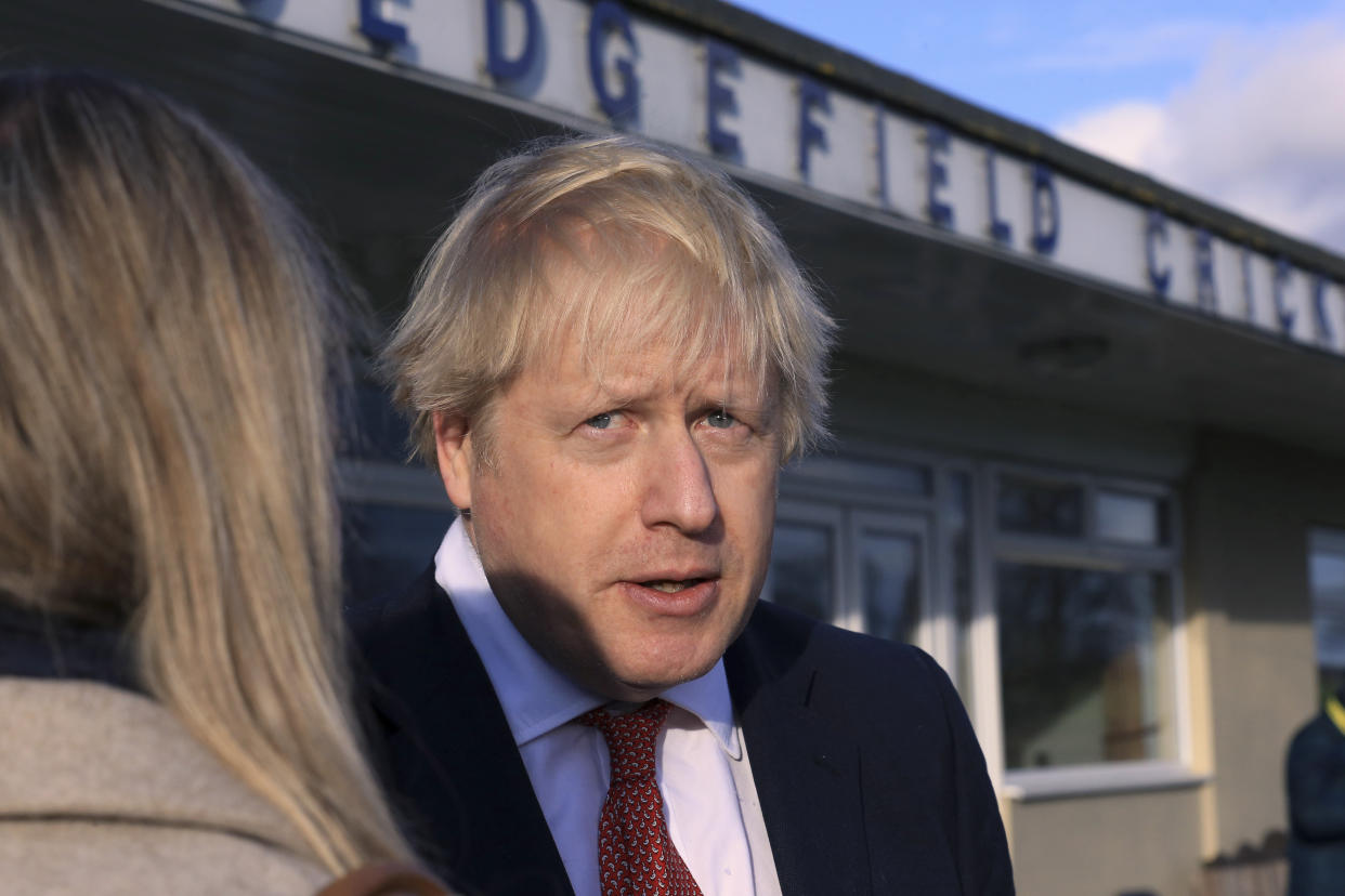 Britain's Prime Minister Boris Johnson, gives an interview during a visit to meet newly elected Conservative party MP for Sedgefield, Paul Howell, at Sedgefield Cricket Club in County Durham, north east England, Saturday Dec. 14, 2019, following his Conservative party's general election victory.  Johnson called on Britons to put years of bitter divisions over the country's EU membership behind them as he vowed to use his resounding election victory to finally deliver Brexit. (Lindsey Parnaby/Pool via AP)