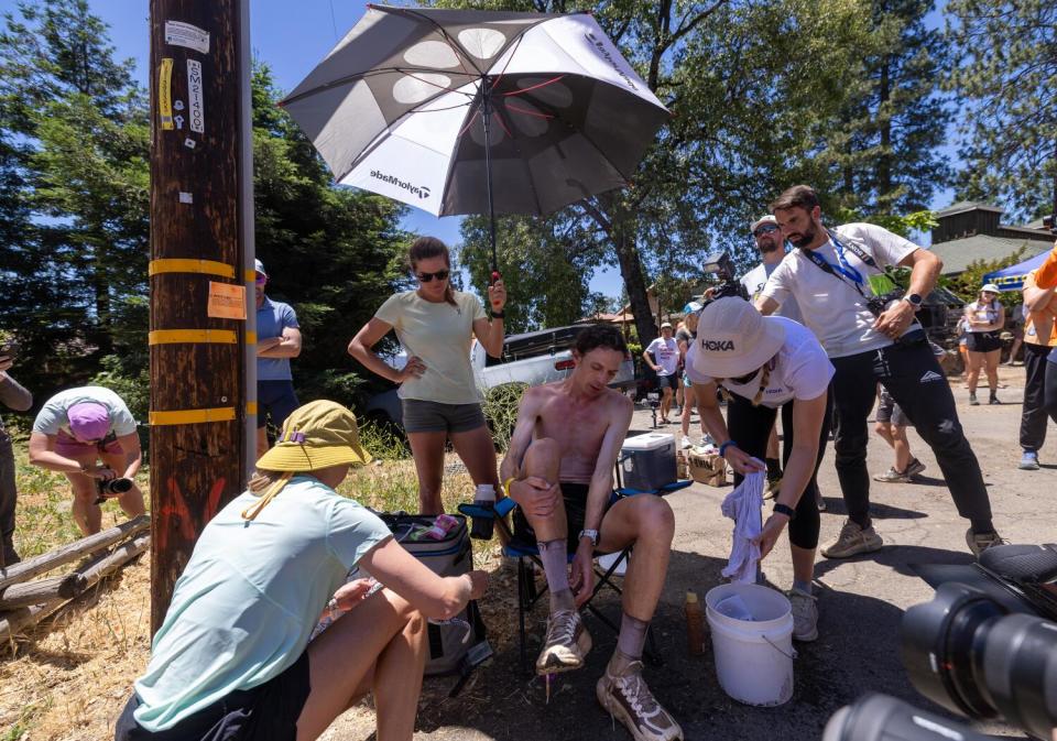 Front-runner Jim Walmsley is the center of attention as his crew tends to cooling and hydration.