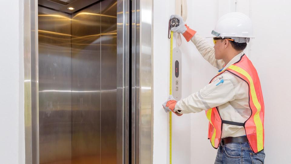 Technician - Engineer investigate work adjustment mechanism lifts the elevator.