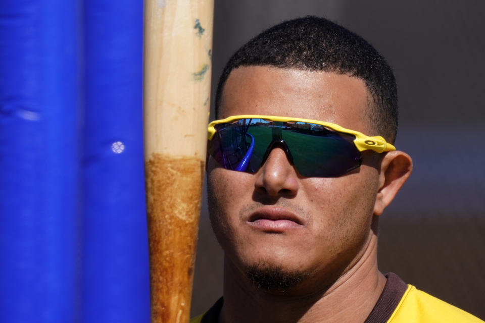 San Diego Padres' Manny Machado looks at his bat during spring training baseball practice Tuesday, Feb. 23, 2021, in Peoria, Ariz. (AP Photo/Charlie Riedel)