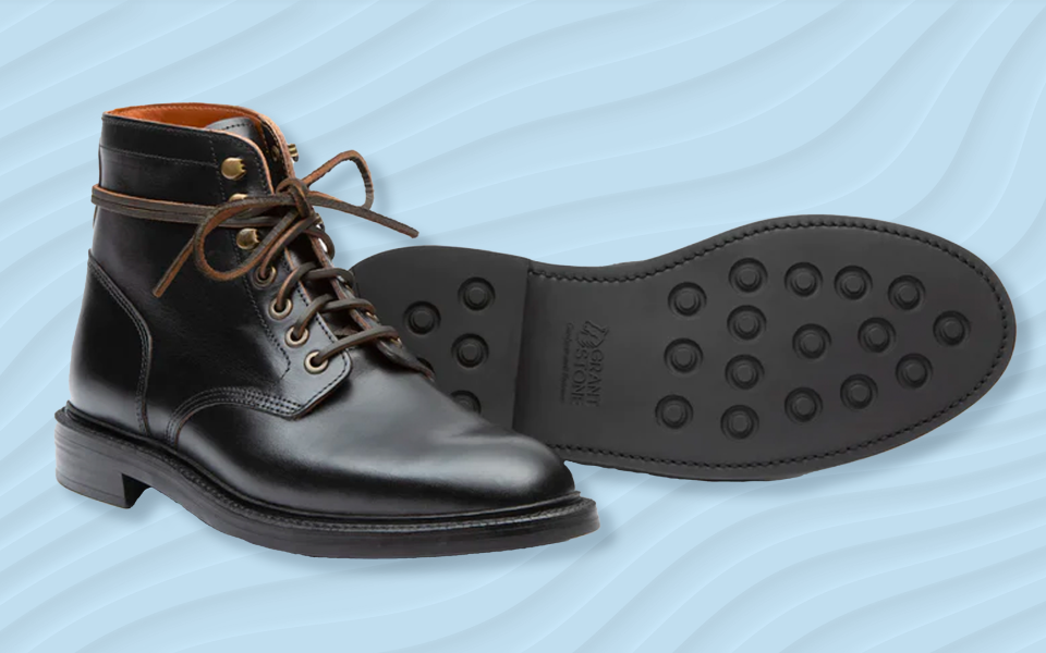 the grant stone diesel boot in black leather against a wavy blue background