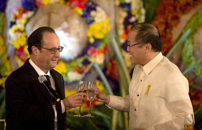 Philippine President Benigno Aquino (R) shares a toast with French President Francois Hollande (L) during a state dinner at the Malacanang Palace in Manila on February 26, 2015