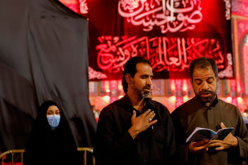 FILE PHOTO: Shi'ite Muslim pilgrims read prayers as they commemorate the Arbaeen, in Kerbala